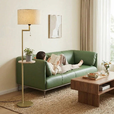 lampadaires lampagère femme allongée sur canapé avec un livre et un plateau repas