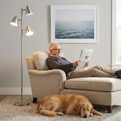 lampadaire lampaspots monsieur regardant son journal installé dans son fauteuil